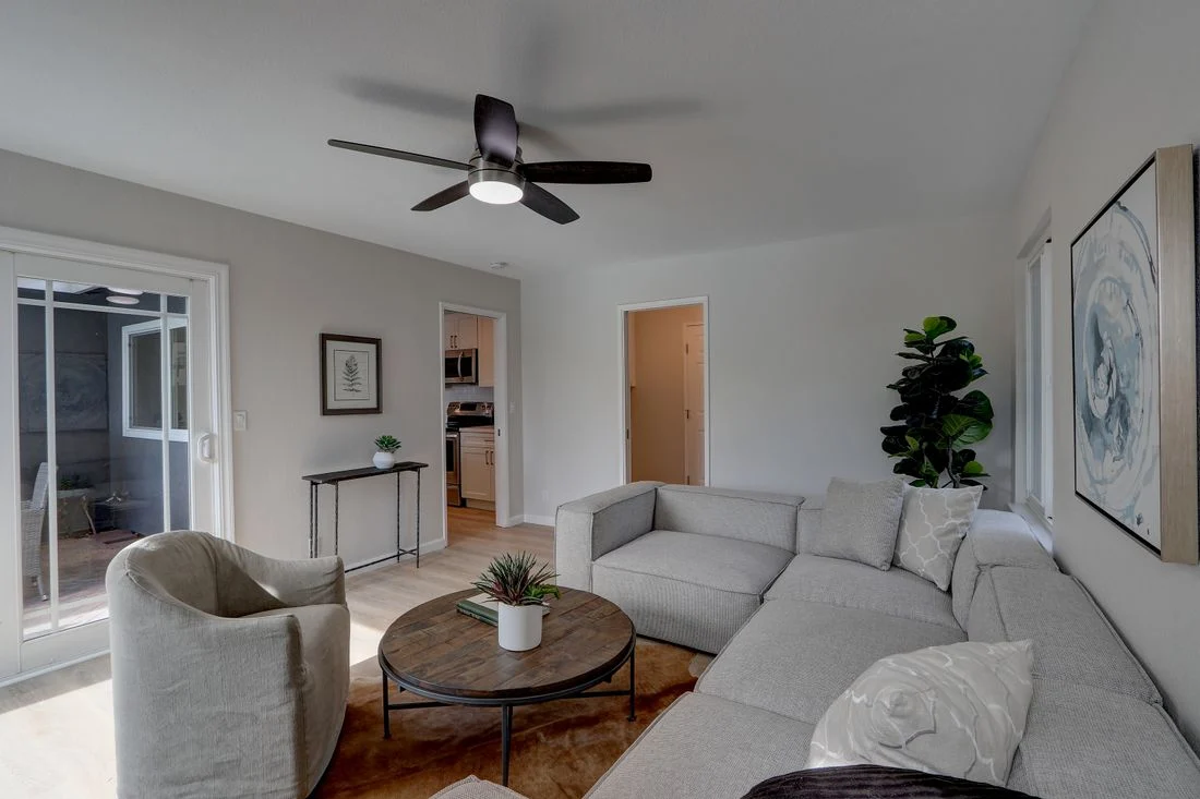 Light sectional sofa with a rounded armchair and coffee table