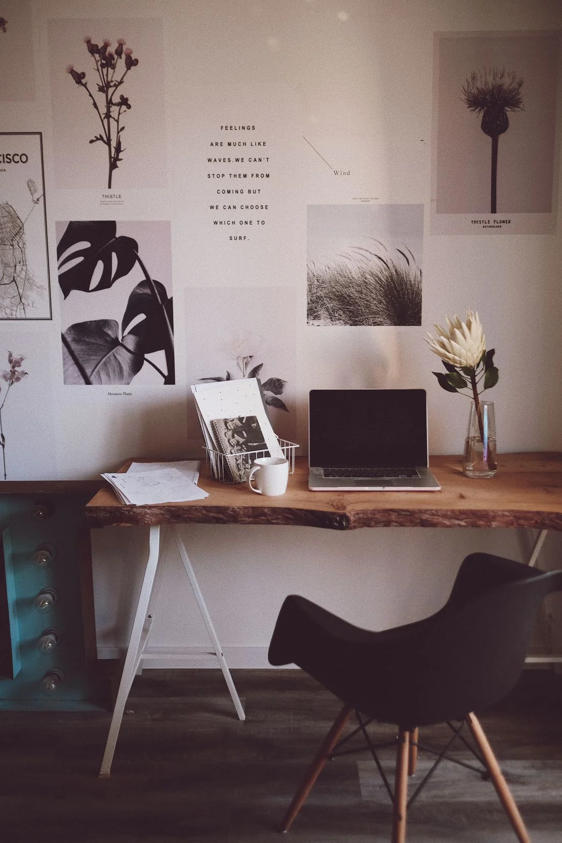 Wooden desk and dark chair in a decorated room corner