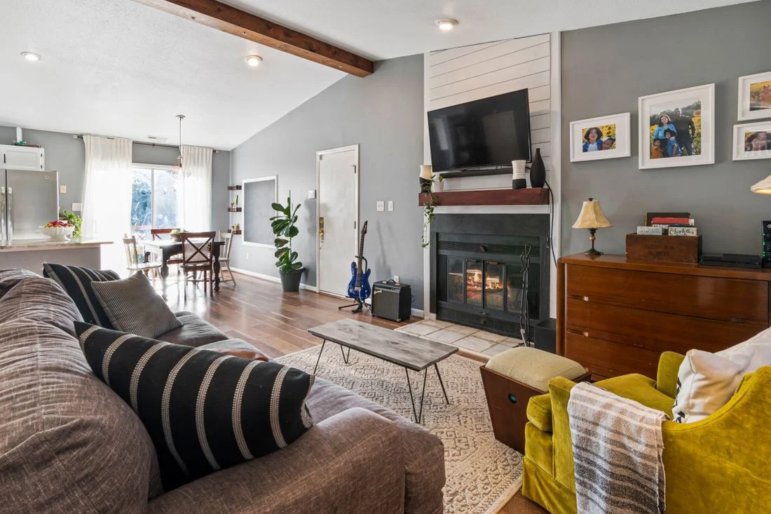 Living room seating beside a fireplace and tall cabinet
