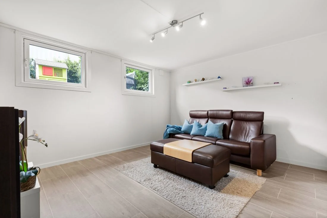 Dark brown leather seating against light walls