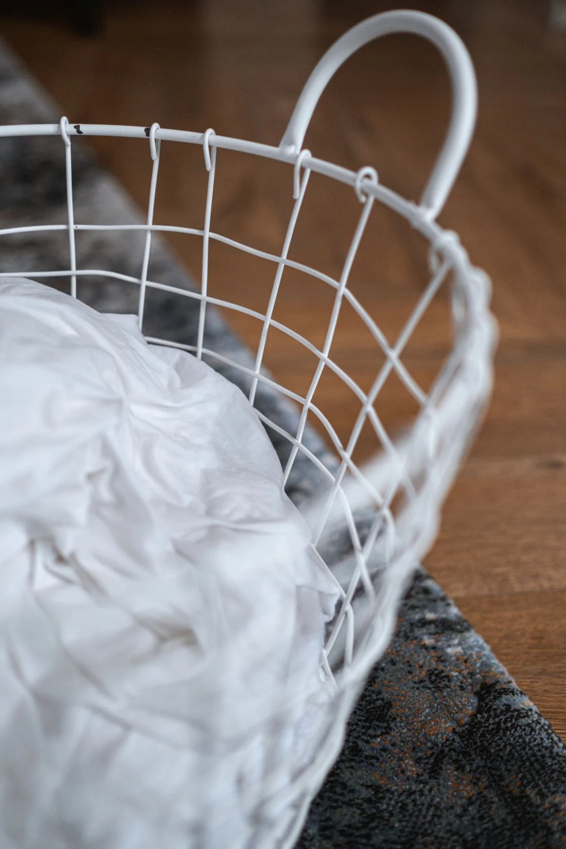 White clothing in a wire laundry basket