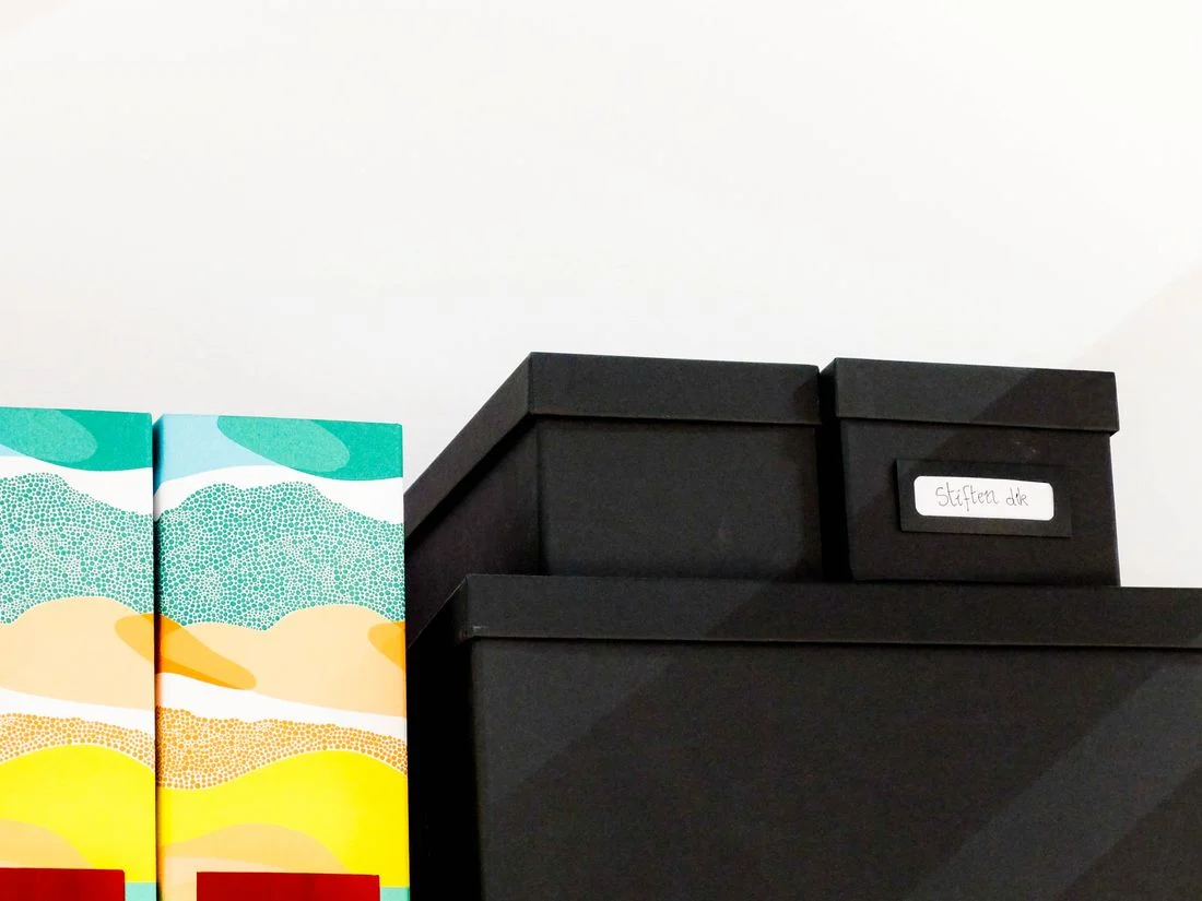 Labeled black storage boxes