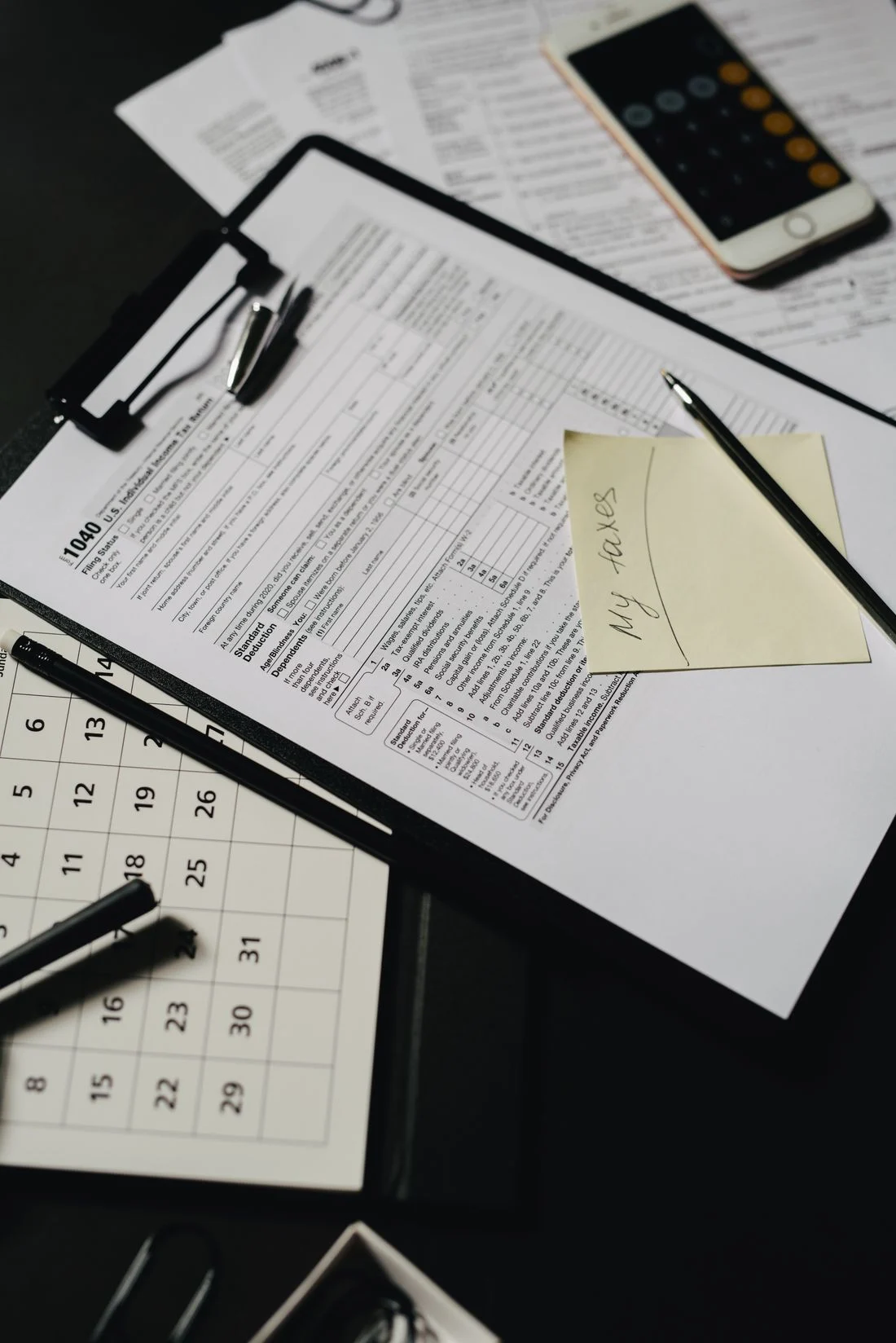 Documents and stationery arranged on a desk