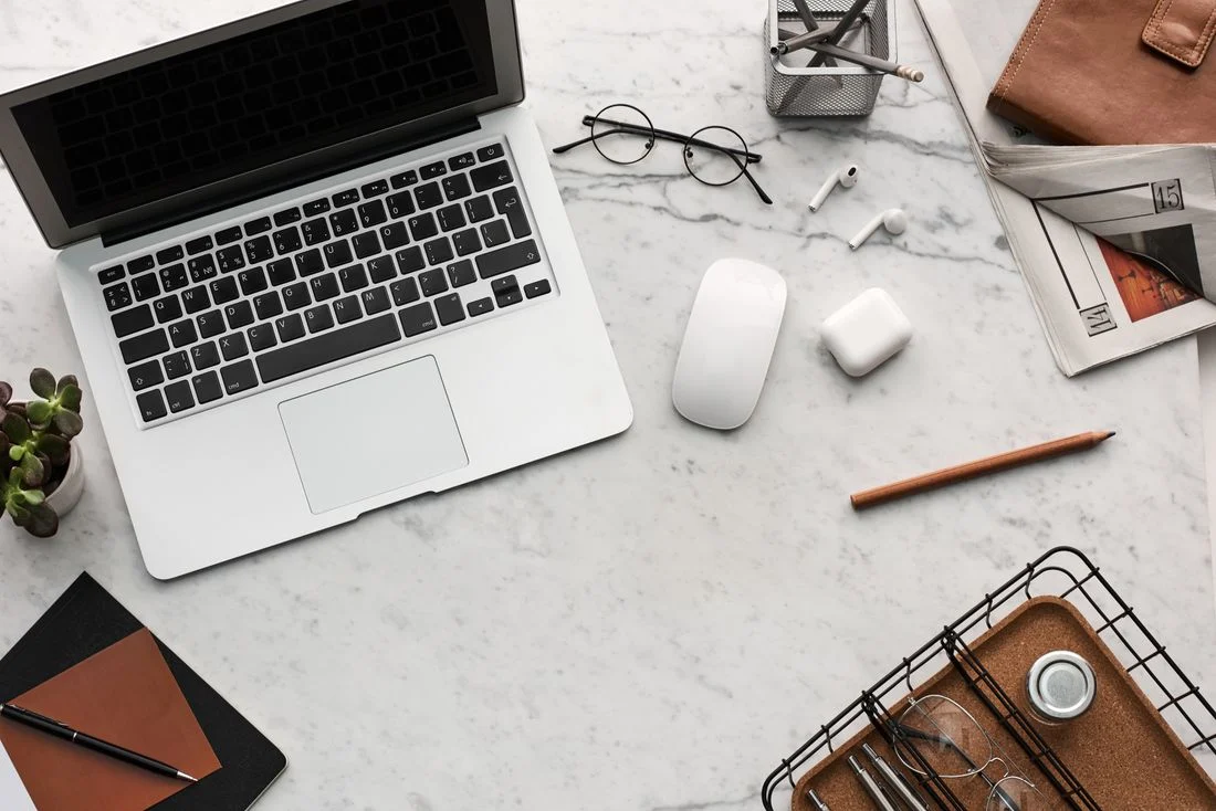 Laptop and small electronics on a desk
