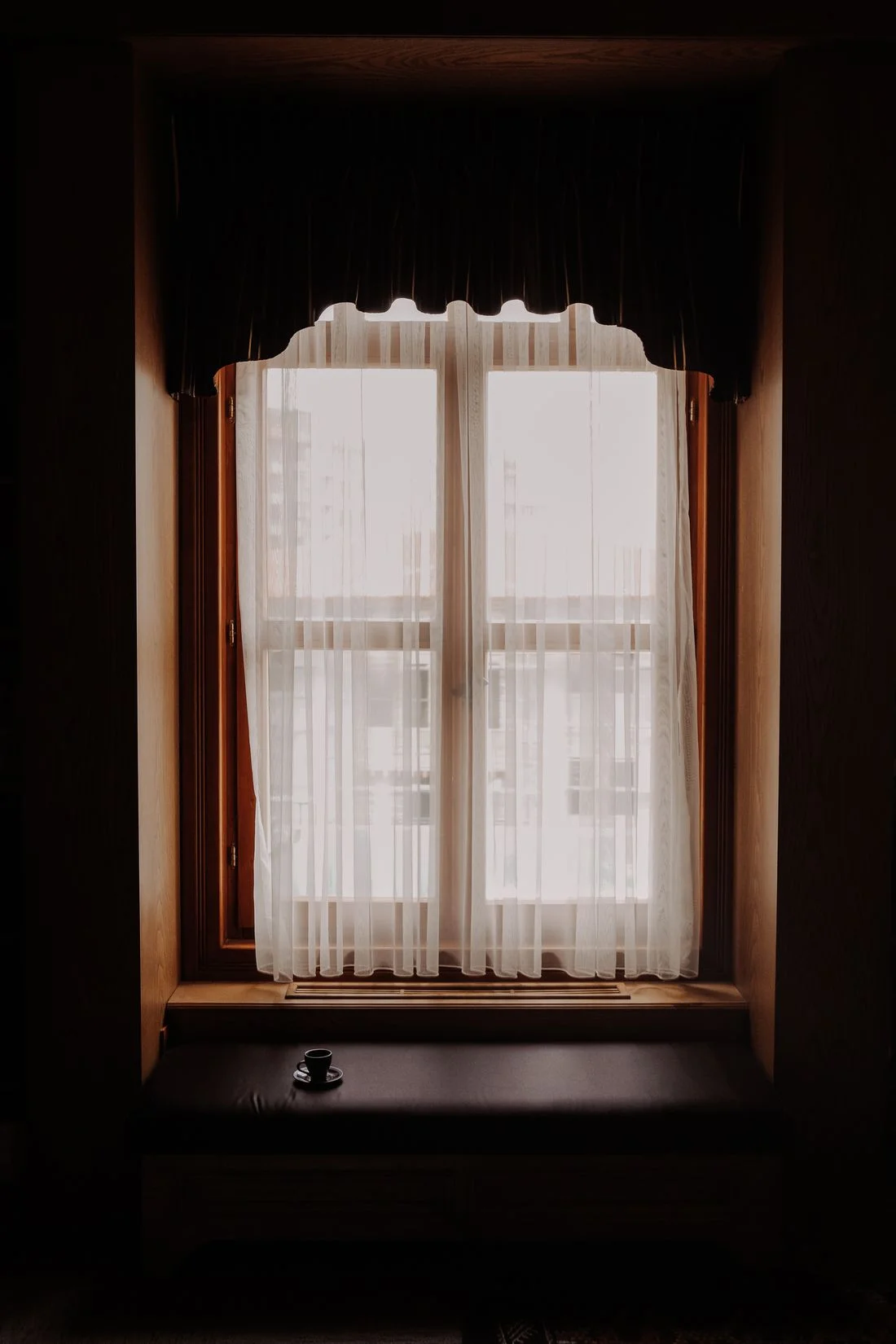 Sheer curtains filtering warm window light