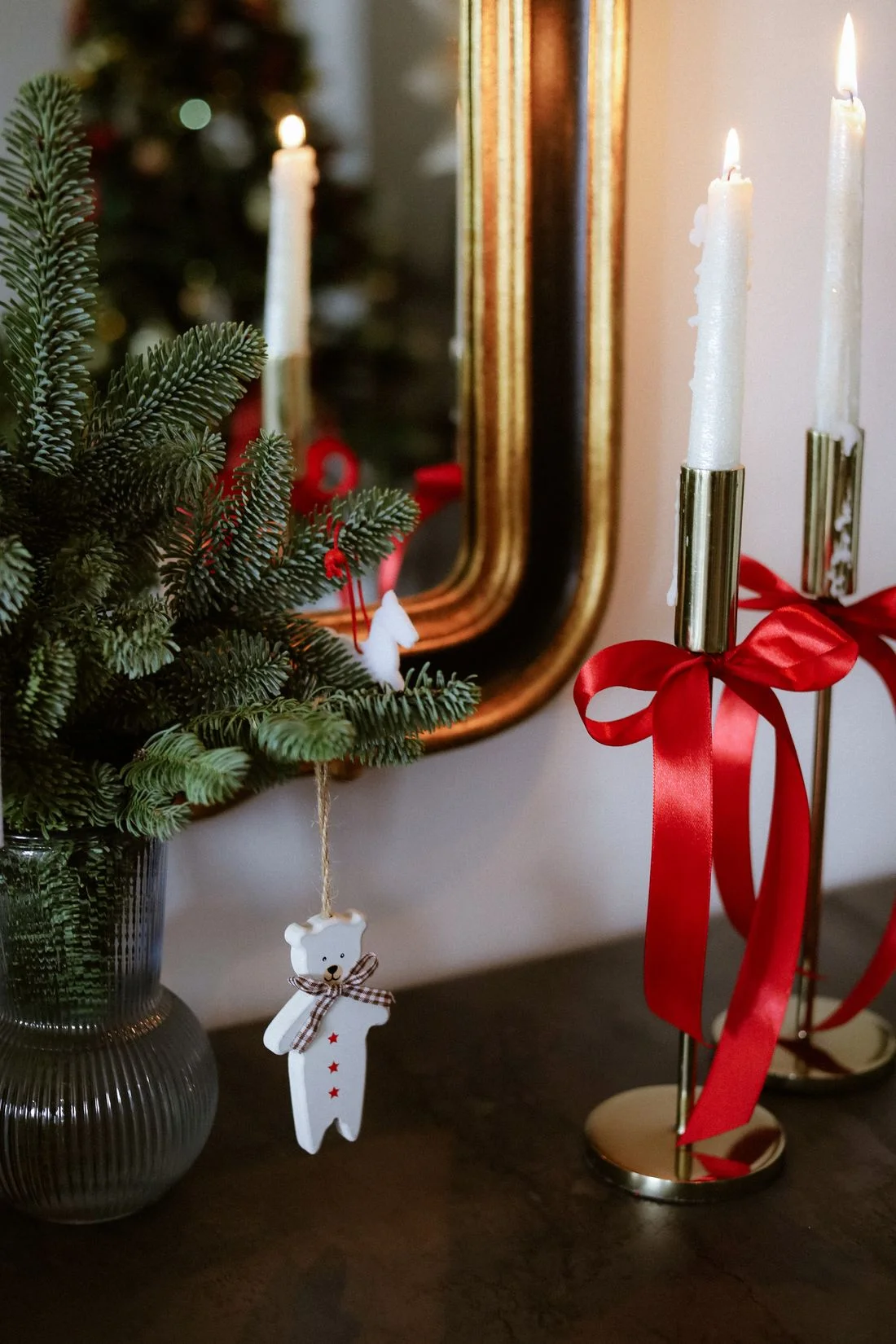 Seasonal greenery, ribbon and candle decorations