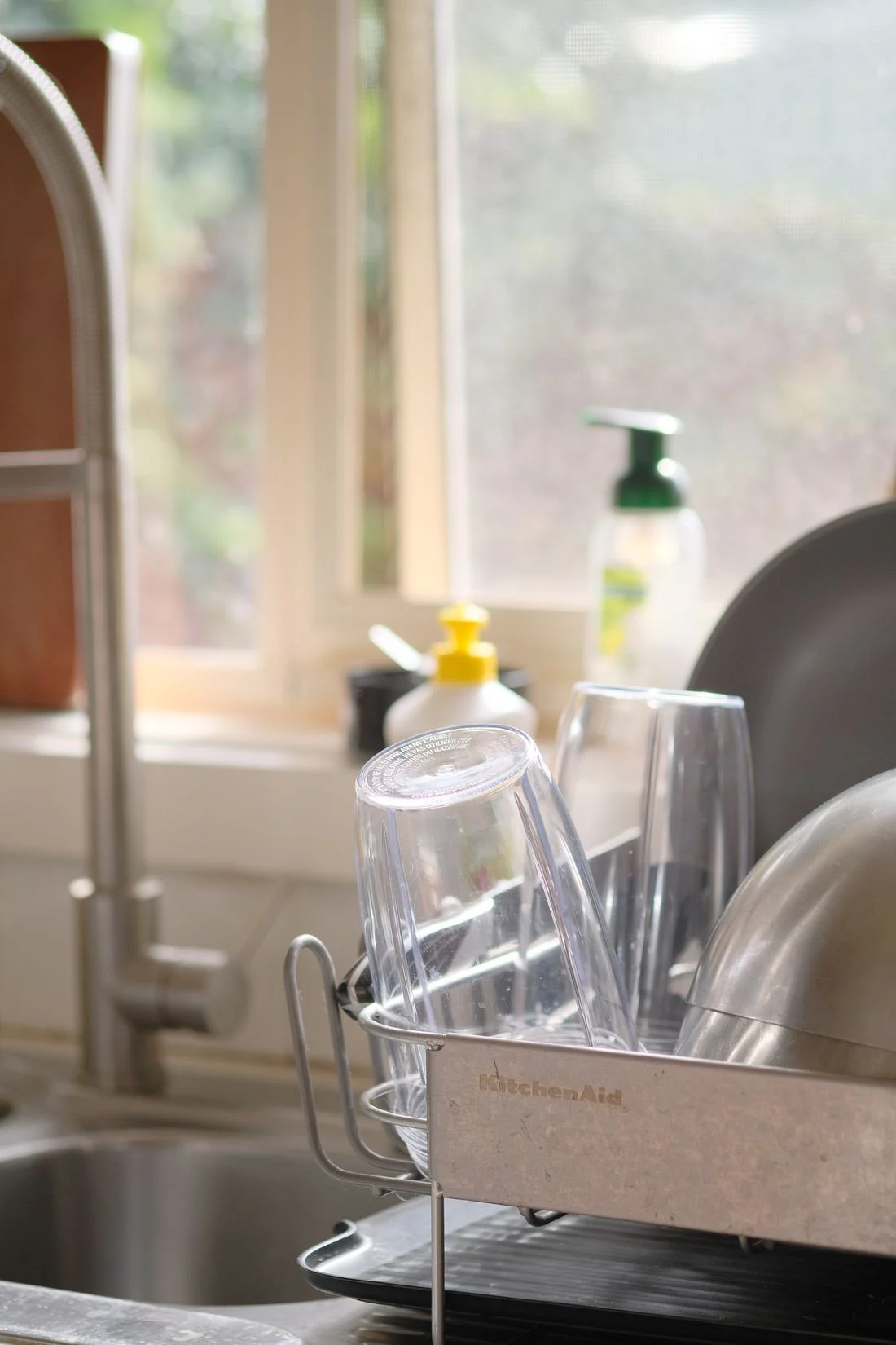 Drinking glasses drying near a kitchen sink