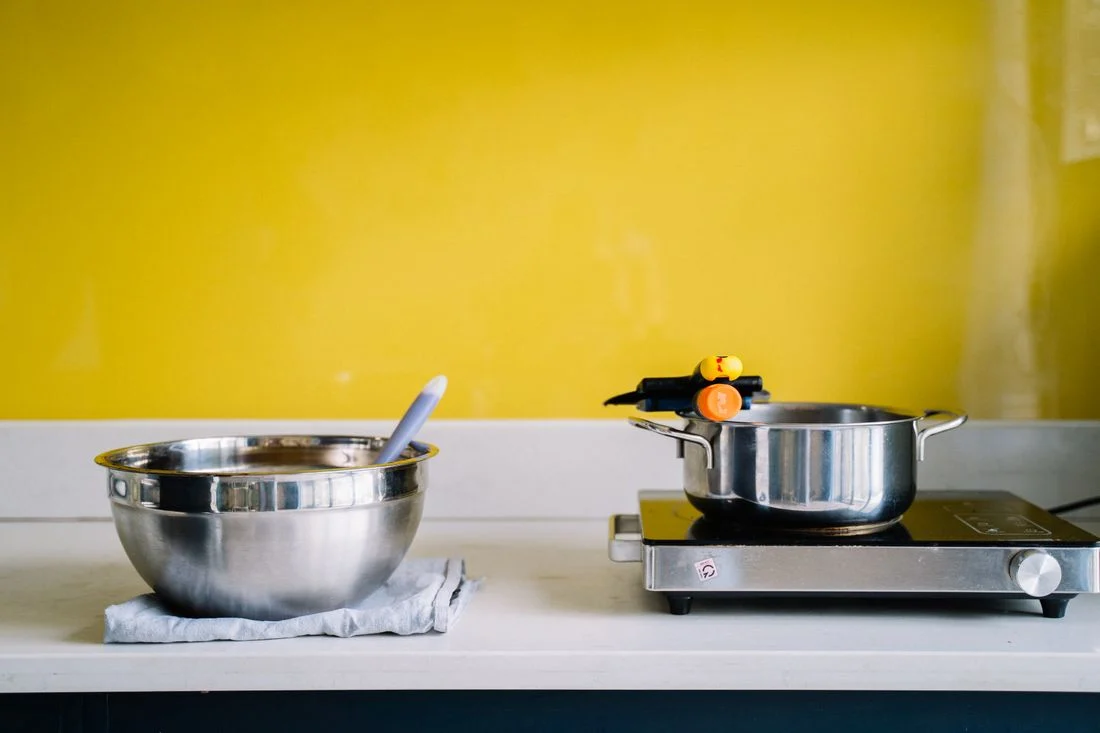 Stainless cooking pot on a kitchen work surface