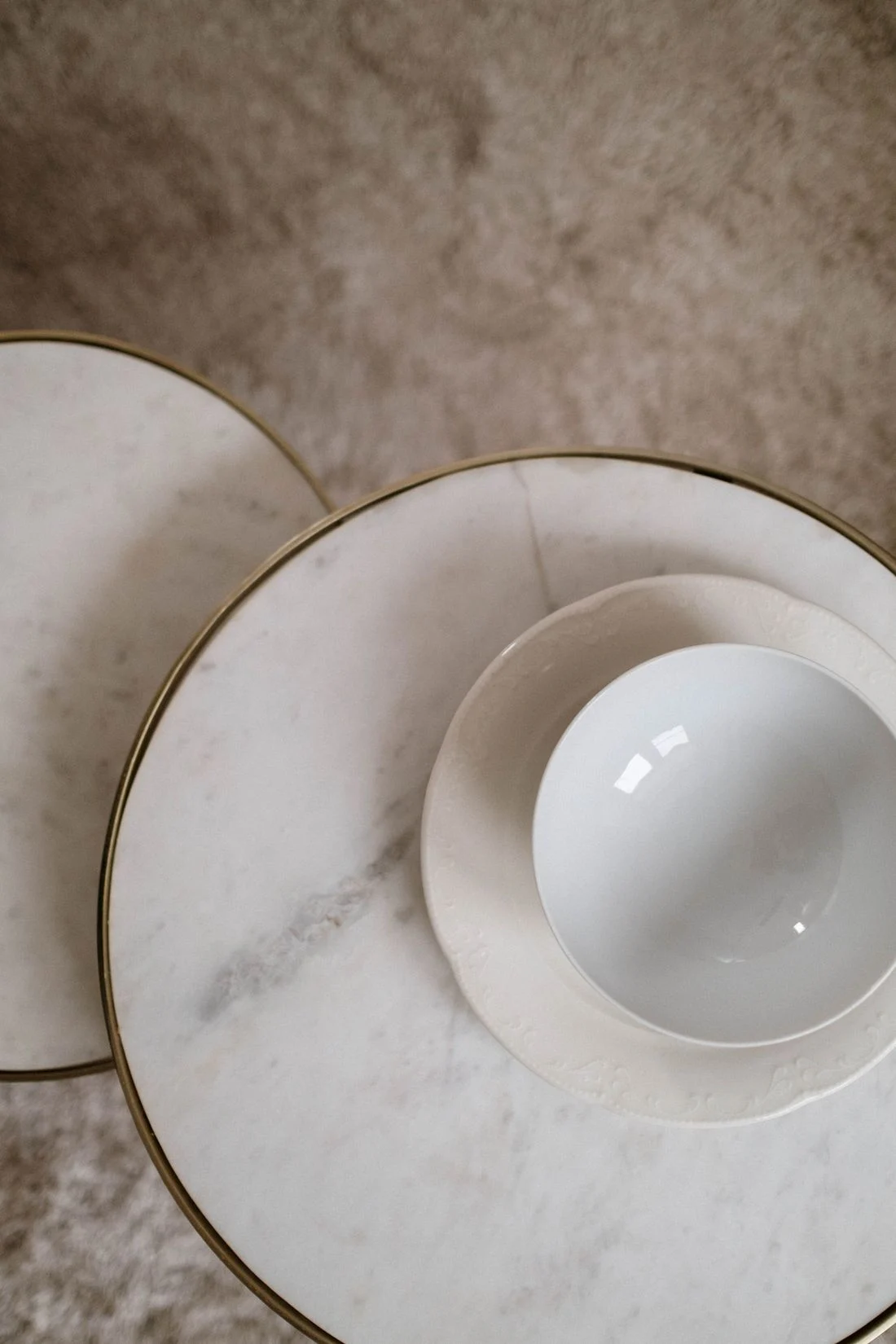 White bowl and ceramic plate on a table
