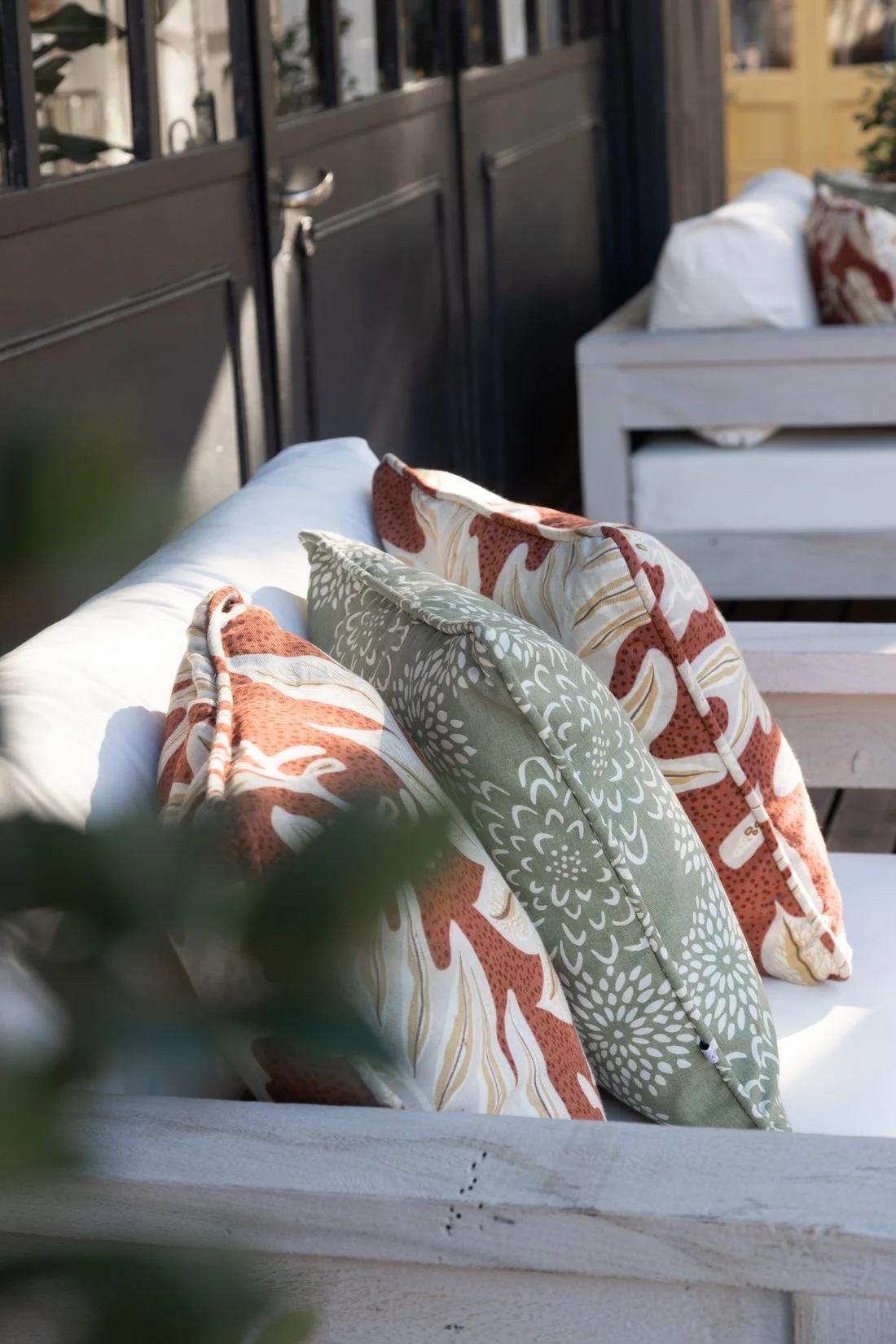 Colorful cushions on wooden outdoor furniture